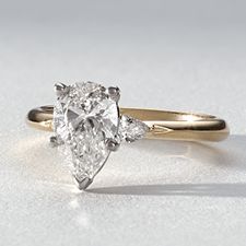 A diamond engagement ring with a pear center stone