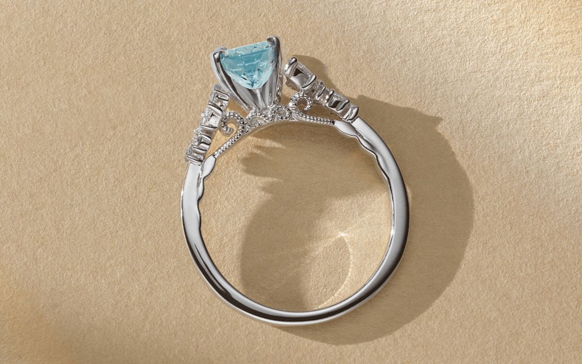 A cathedral engagement ring with a colored center stone