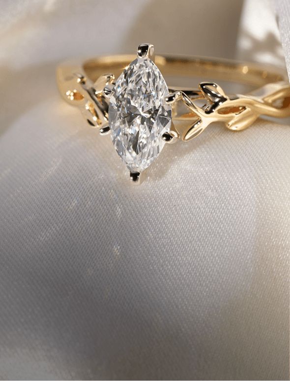 A diamond engagement ring on a white cloth background