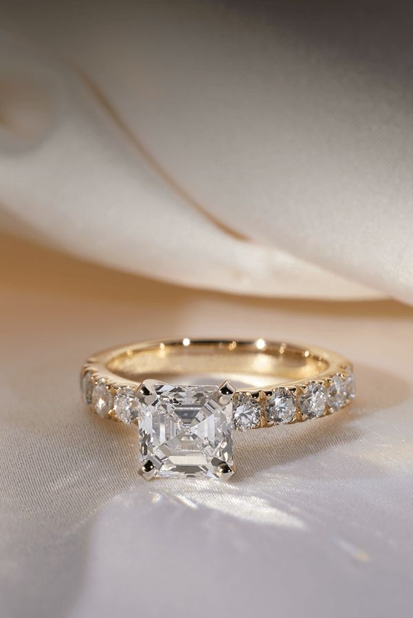 A diamond engagement ring surrounded by white cloth