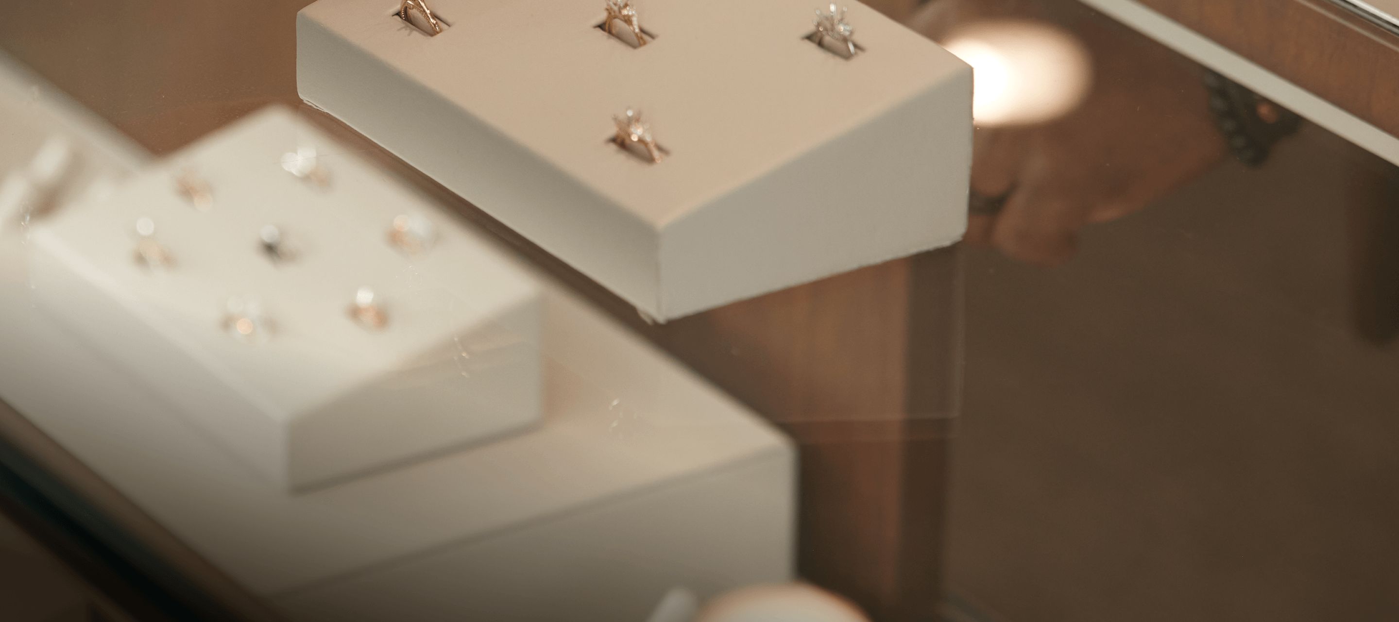 A jewelry box showing a collection of diamond engagement ring settings