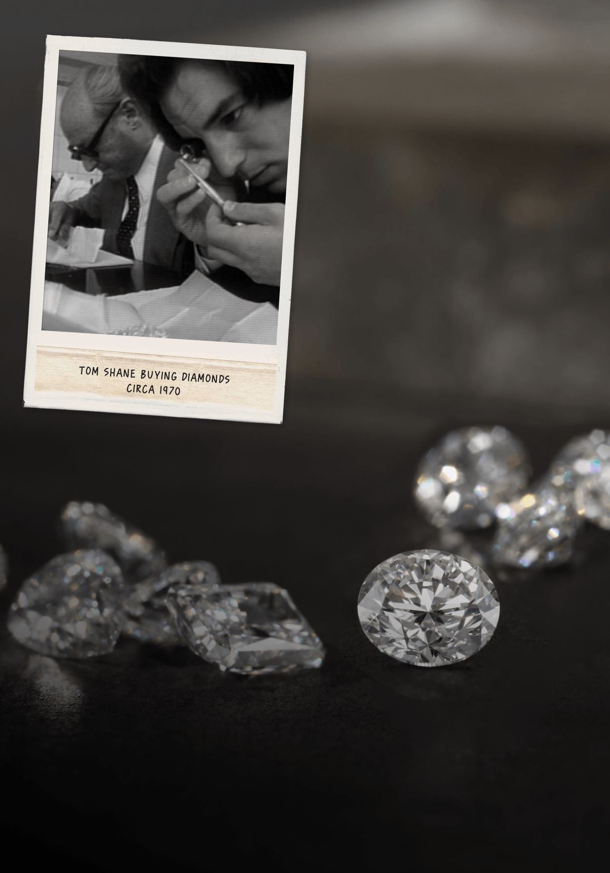 Loose diamonds laying on a dark table top