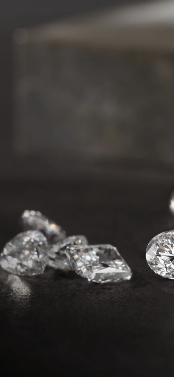 Loose diamonds laying on a dark table top