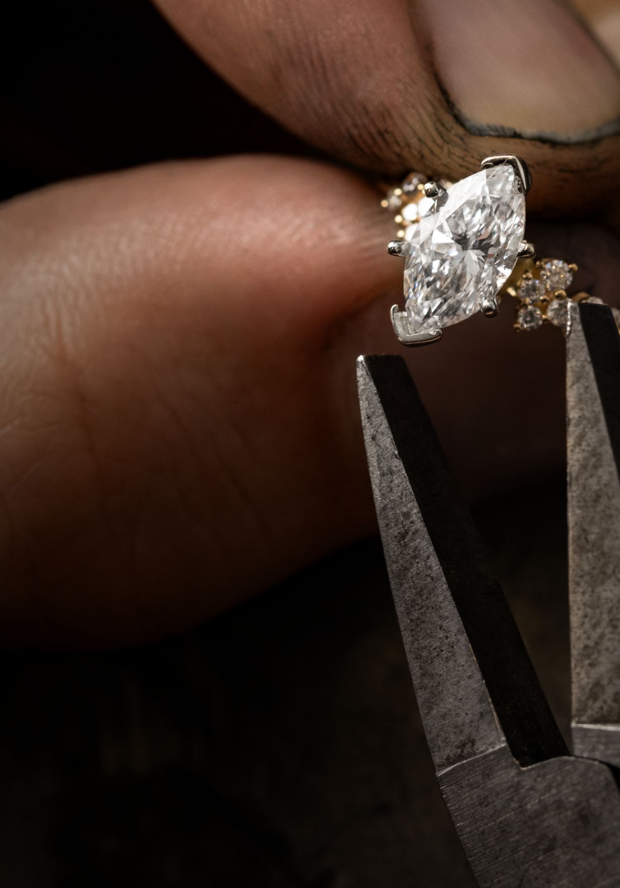 A jeweler setting a center stone in an engagement ring