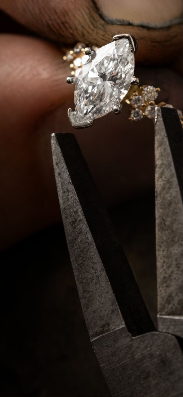 A jeweler setting a center stone in an engagement ring