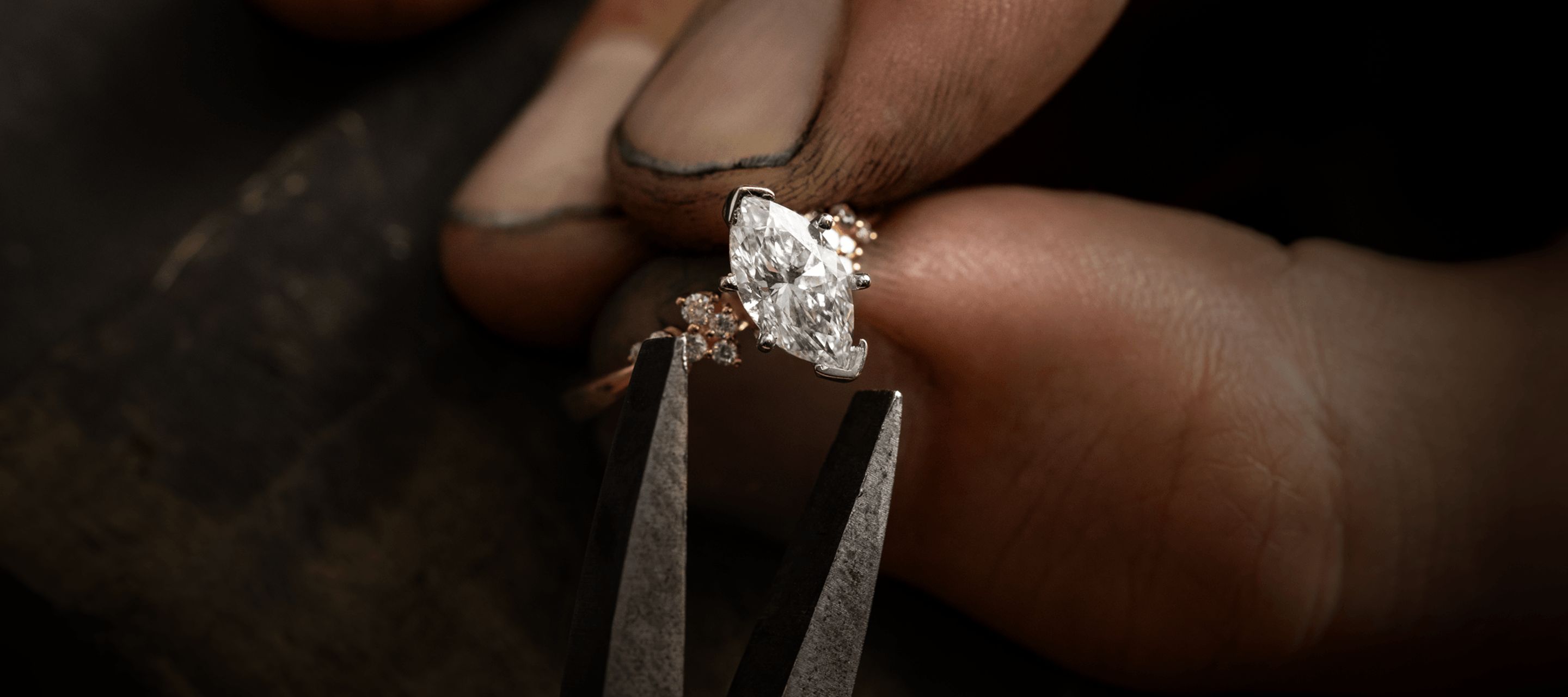 A jeweler setting a center stone in an engagement ring