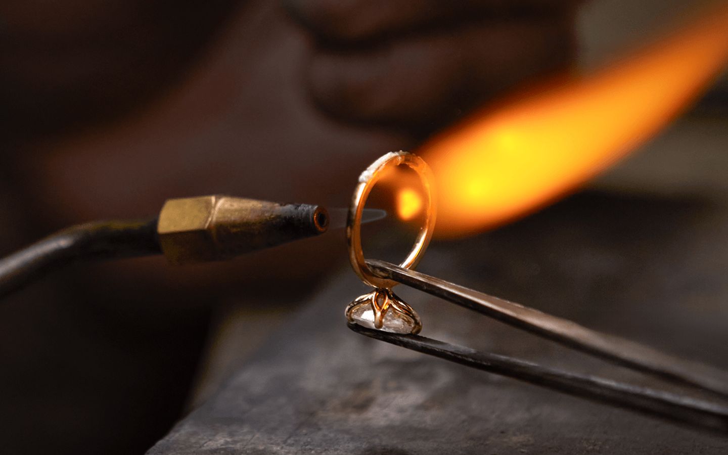 A jewelers torch working on an engagement ring