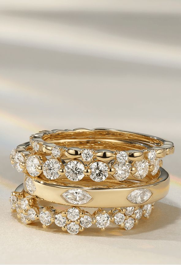 A collection of diamond wedding bands stacked on top of each other