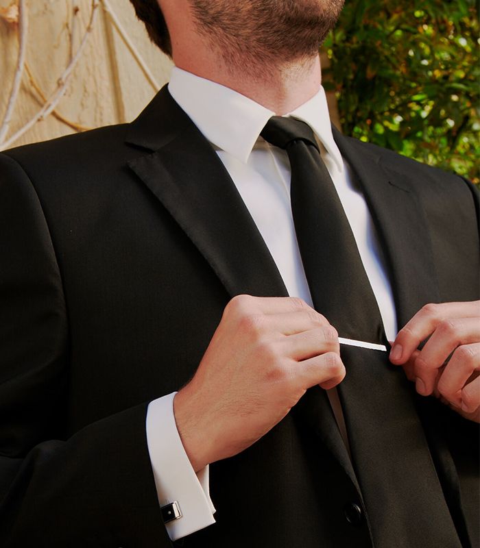 Mobile image of a Groomsman putting on Tie Clip