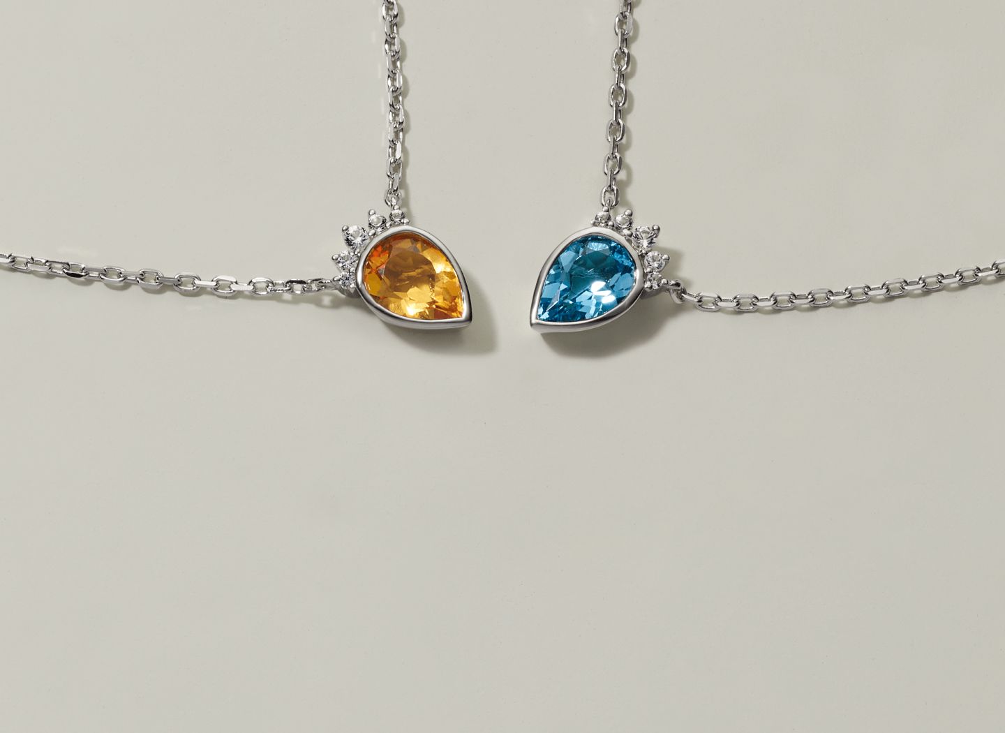 2 gemstone pendants of different colors