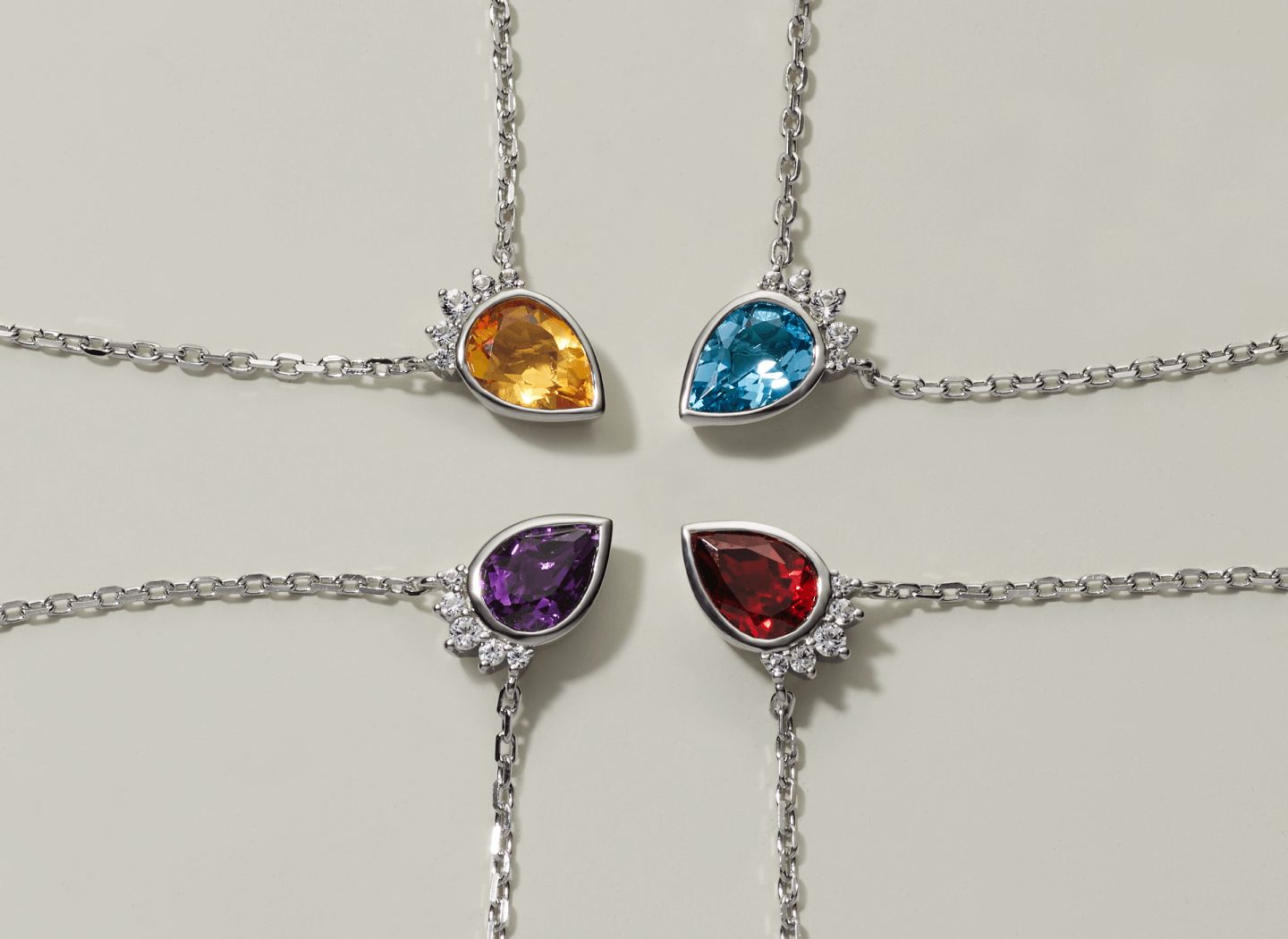 4 gemstone pendants of different colors