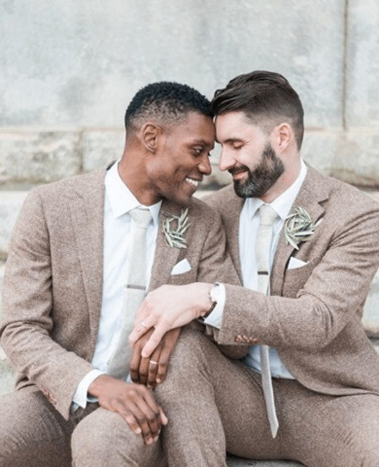 Two grooms posing for a photo