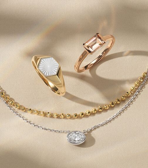 Two fashion rings above two fashion necklaces