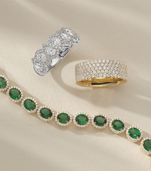 A ruby and diamond fashion bracelet and two diamond fashion rings