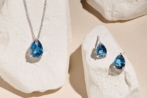 Mobile image of a pair of gemstone earrings and matching gemstone pendant