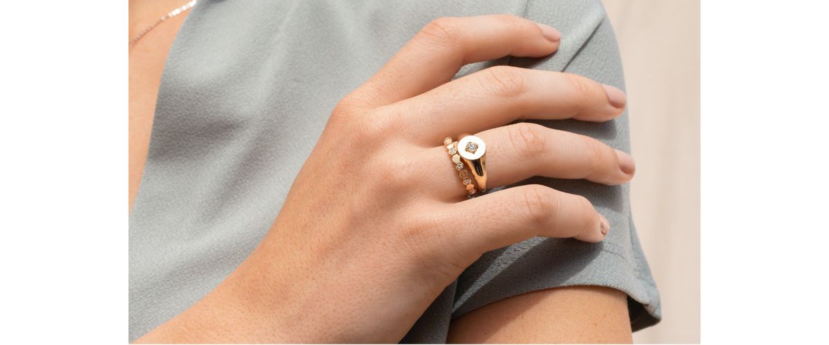 Mobile image of a woman wearing two stacked fashion rings