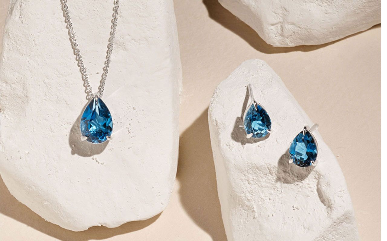 A pair of gemstone earrings and matching gemstone pendant