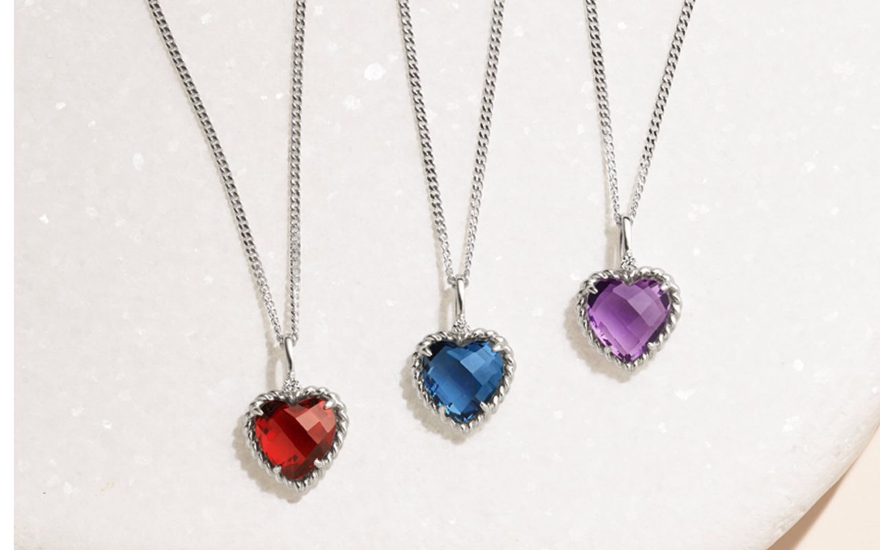 A collection of heart shaped gemstone pendants