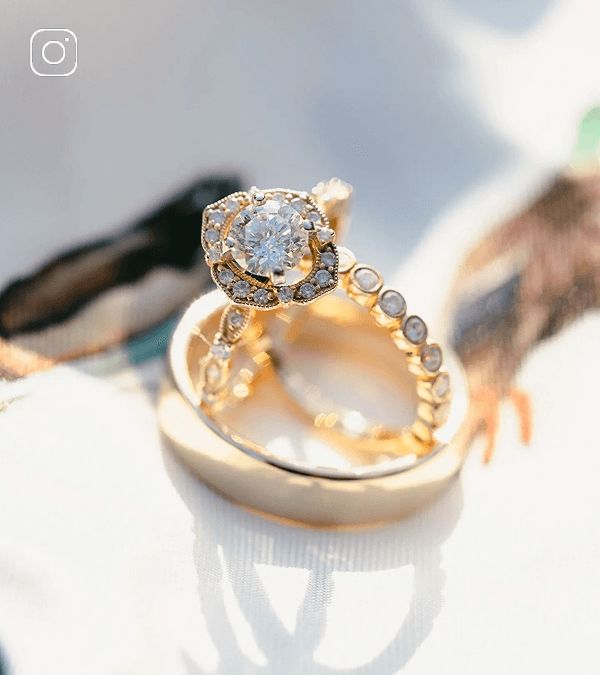 A diamond engagement ring and wedding band inside of a men's wedding band