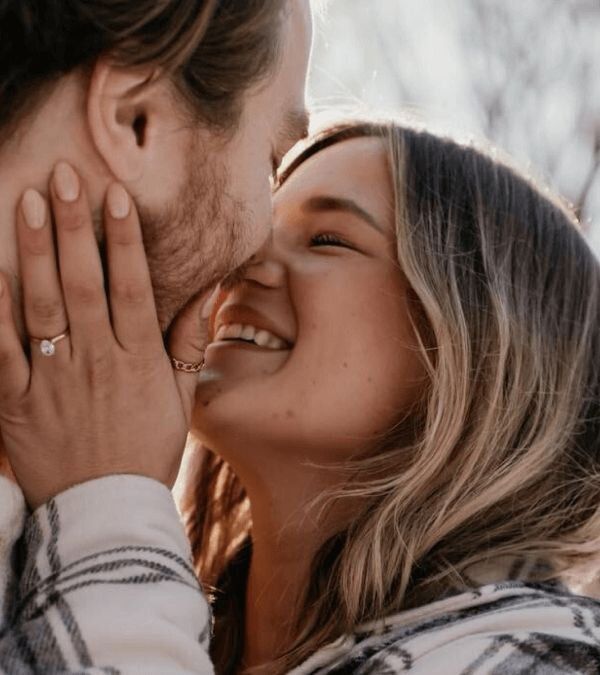 A couple embracing an smiling