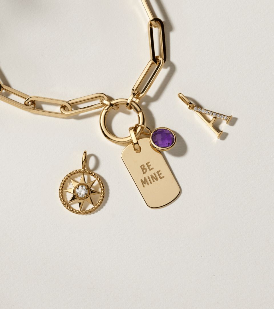 A paperclip necklace surrounded by charms