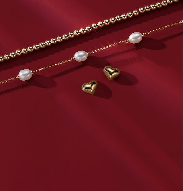 A collection of valentine's day jewelry on a red background