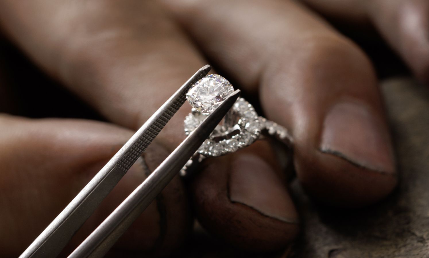 A jeweler setting diamond into an engagement ring