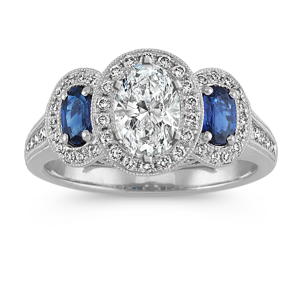 Oval Sapphire and Diamond Three-Stone Halo Engagement Ring