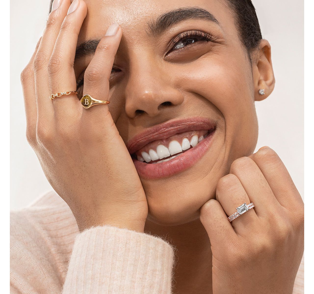 A woman wearing a collection of fashion rings