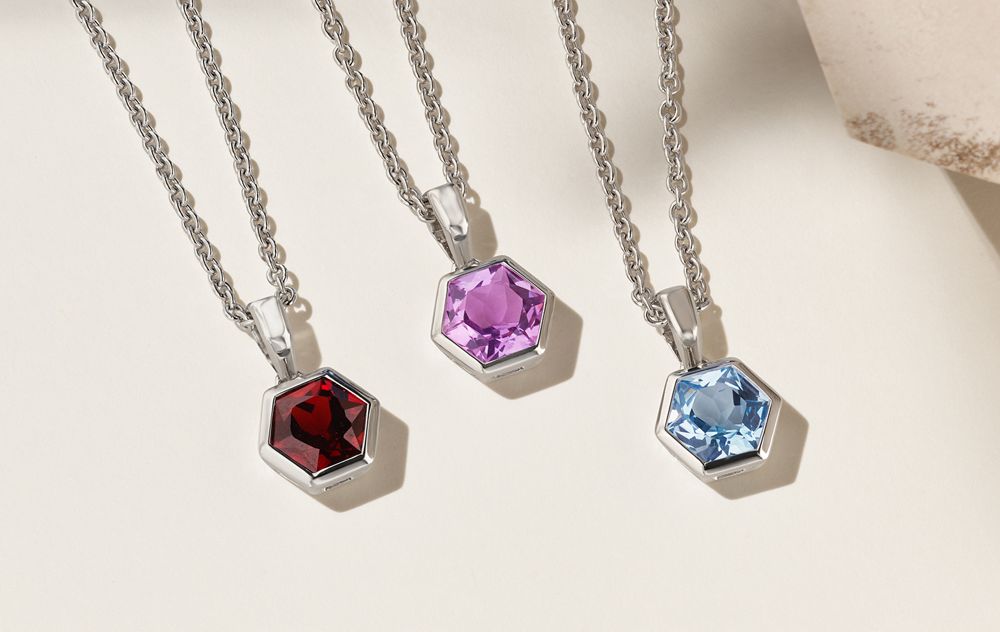A collection of silver gemstone pendants
