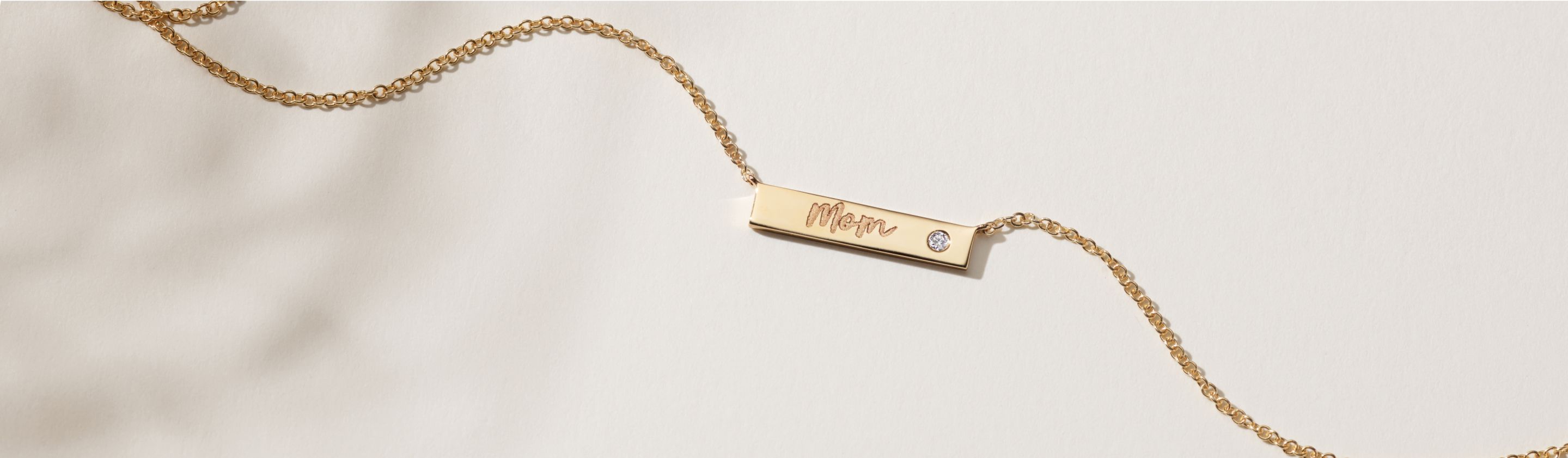 An engraved bar necklace with an inset diamond