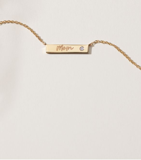 An engraved bar necklace with an inset diamond