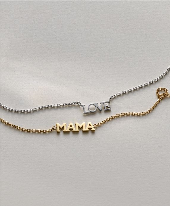 A pair of necklaces that say love and mama