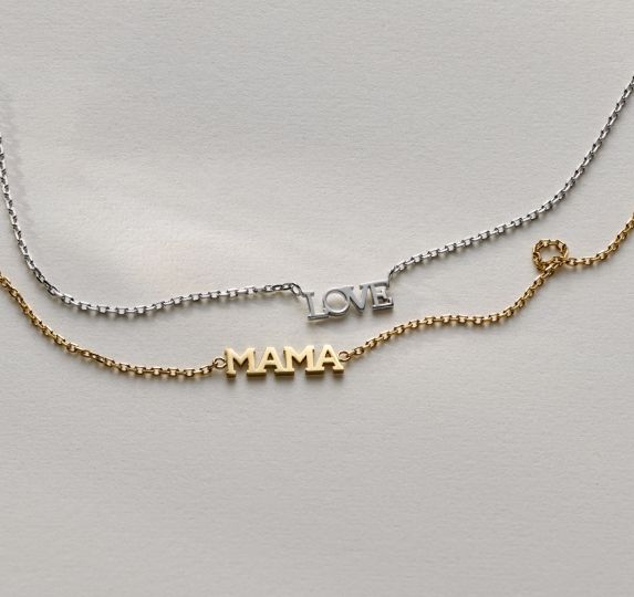 A pair of necklaces that say love and mama